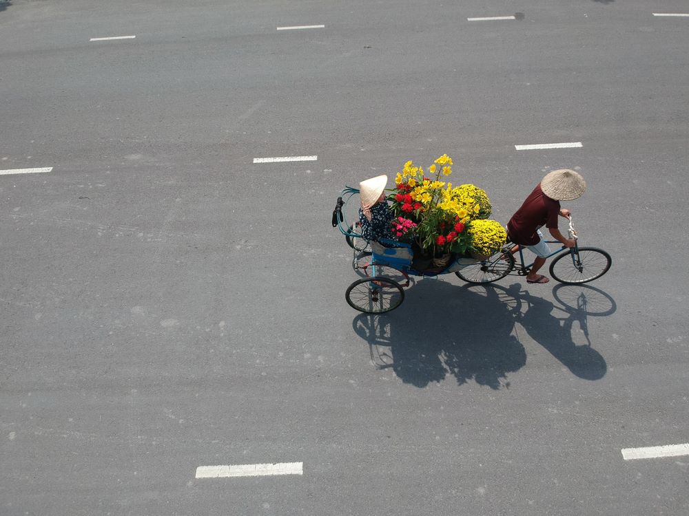 Flowers are being transforted to local market by a traditional tricycle